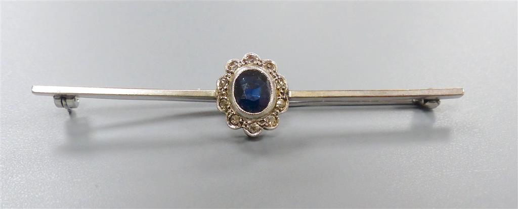 An early 20th century white metal , sapphire and diamond cluster set bar brooch, 58mm, gross 3.3 grams.